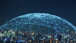 A glowing web above a city skyline symbolizing a communications network.