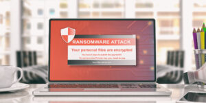 A laptop with a notice on the screen that says "RANSOMWARE ATTACK."