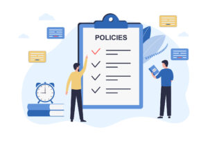 An illustration of a large clipboard that says POLICIES on it, with two small people looking at it. 