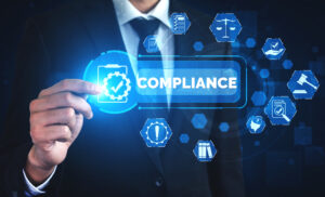 Digital image of a person in a suit and tie pointing to a glowing blue rectangle that says "Compliance" with a check mark.