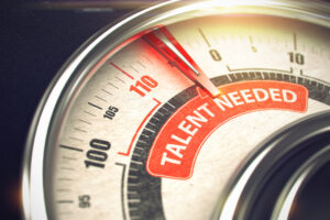 Close-up of a gauge with a needle pointing to text saying "Talent needed."