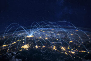 Glowing lines arcing up and away from a single location on the globe, representing a large network.