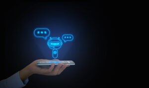 A hand holds out a smartphone against a dark background. A glowing blue robot with two speech bubbles, representing conversational AI, hovers over the smartphone screen.