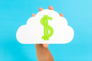 A person holding up a cloud with a dollar sign on it against a blue background.