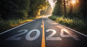 Picture of a road that says "2024" on it in the foreground.