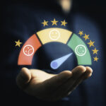 Tech Talks: Cloud contact center solution drives 10-point net promoter score boost Against a dark background, a person holds their hand out, palm up. Above their palm there is a dial that goes from red to yellow to green, with a range of one to five stars. The red section has a frowny face in it and the green has a smiley face, representing customer satisfcation.