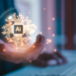 Tech Talks: AI workshop accelerates adoption with expert insights Close up of an outstretched hand with a golden computer chip/circuit board illustration that says "Ai" in the palm.